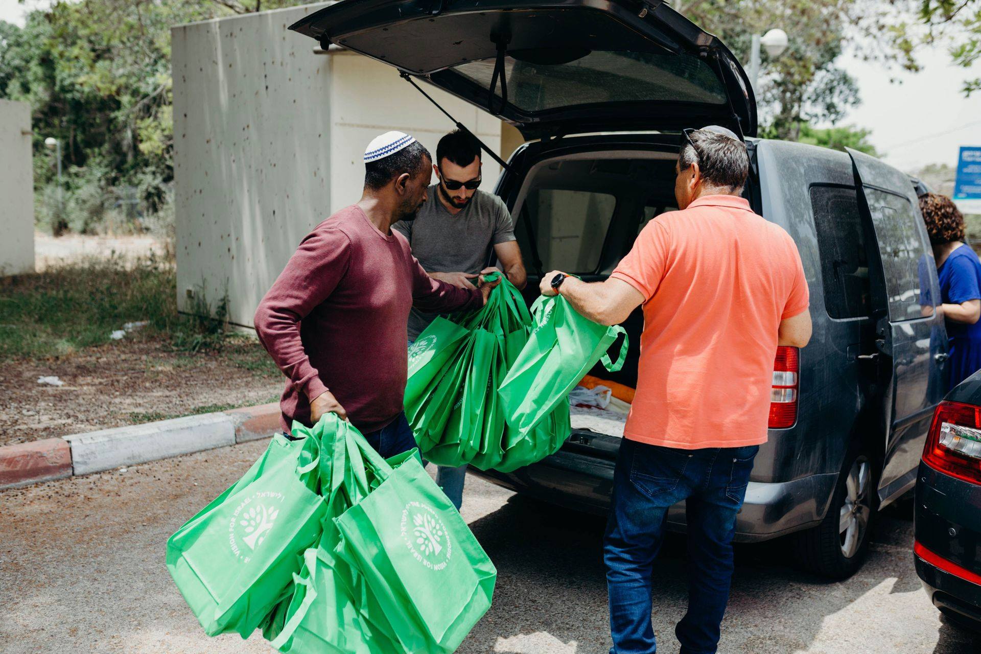 local israelis loading supplies into a car
