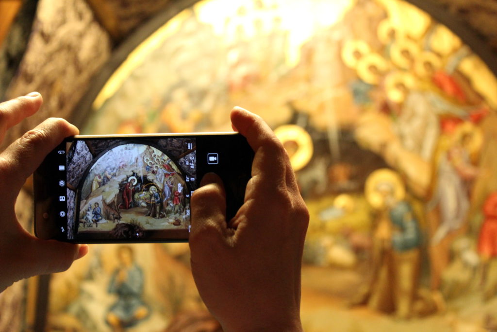someone taking a picture of a painted wall