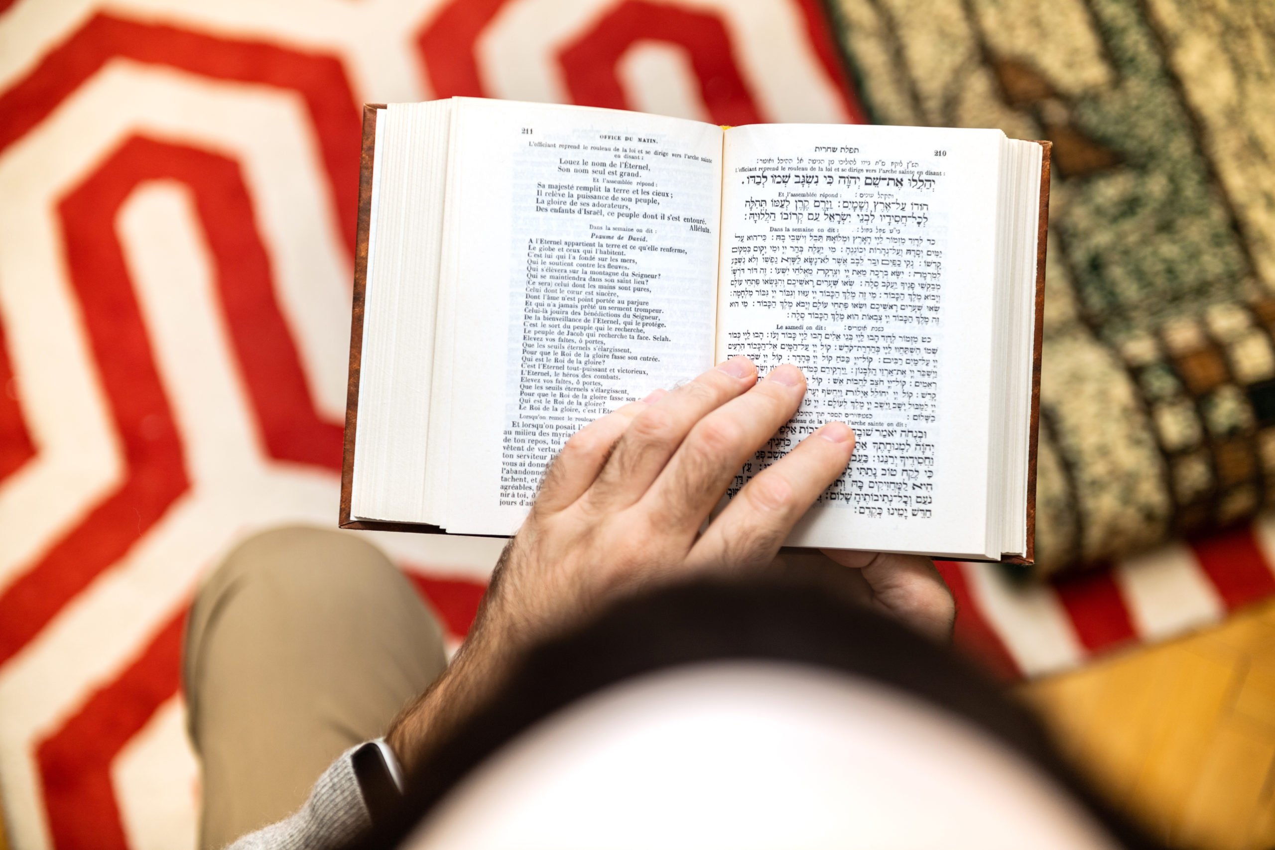 Jewish male wearing Kippah reading Machzor praying book