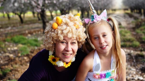 Outdoor portrait almond trees of mother and daughter in purim costumes