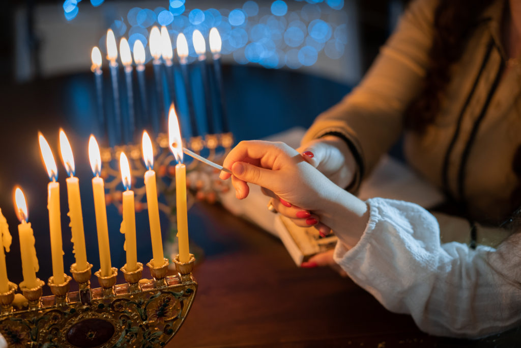 children lighting the menorah