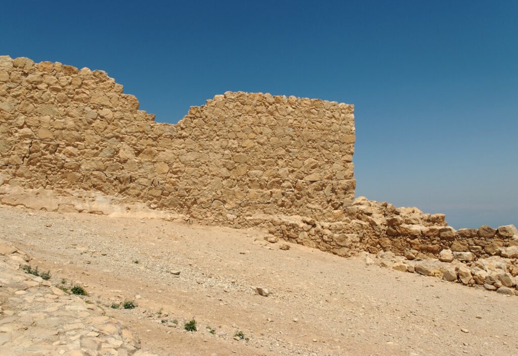 Jagged wall of ancient fortress ruin in the desert near Jericho, Israel
