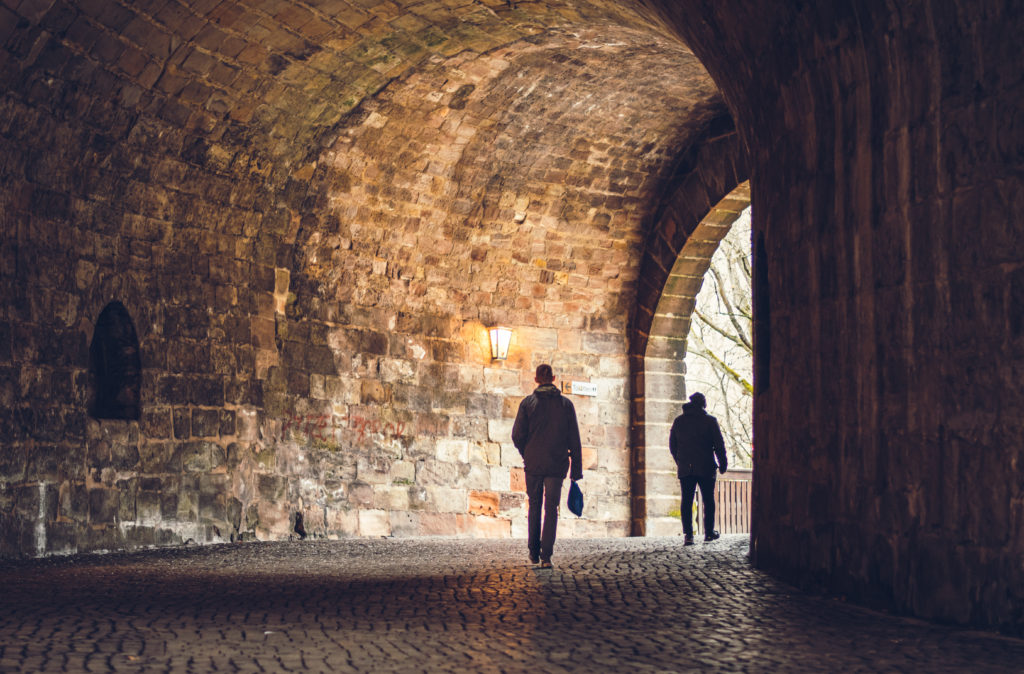 two men walking through a tunnel in the city in Israel