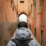 man standing in an ally