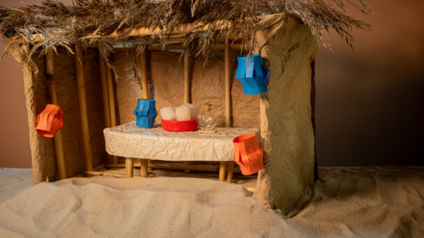 wooden sukkah that looks like a nativity scene and can help explain when jesus was born
