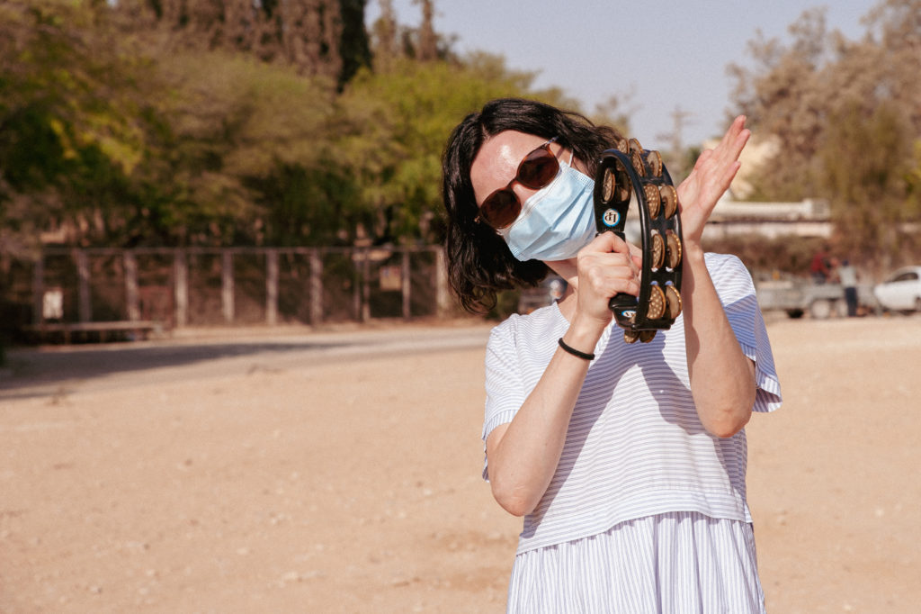 girl playing a tamborine