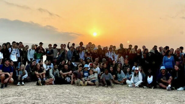 group of teenagers getting a sunset photo