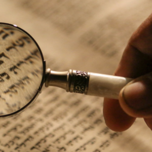 ancient hebrew text with a magnifying glass